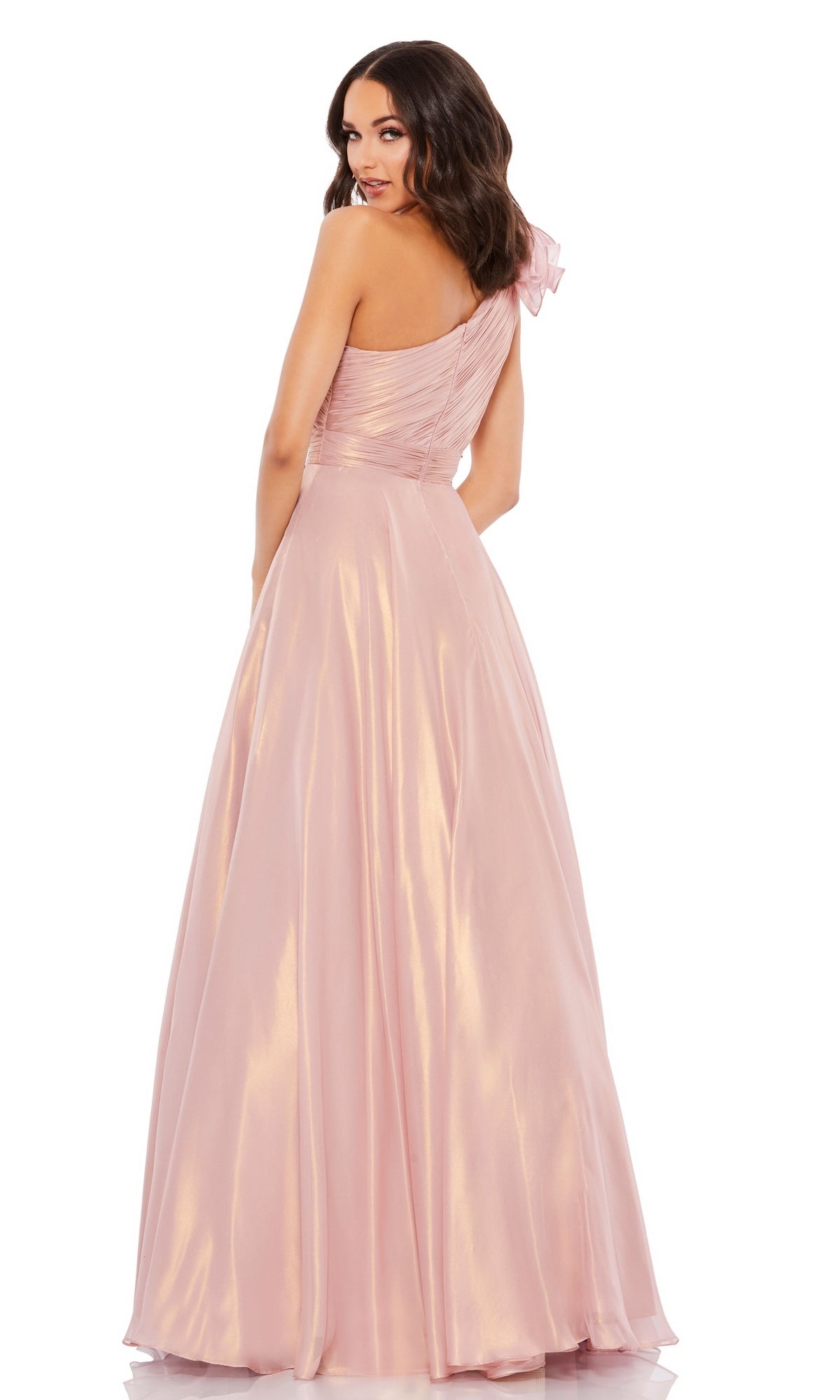 Woman wearing the Mac Duggal 49252 Long Rose Gold Formal Dress with a fitted bodice and flowing skirt, standing and looking over her shoulder in signature Mac Duggal style.